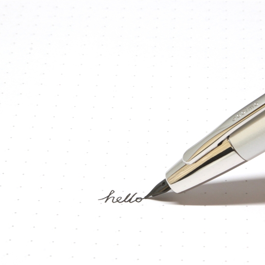 A pen writing 'hello' on dotted paper