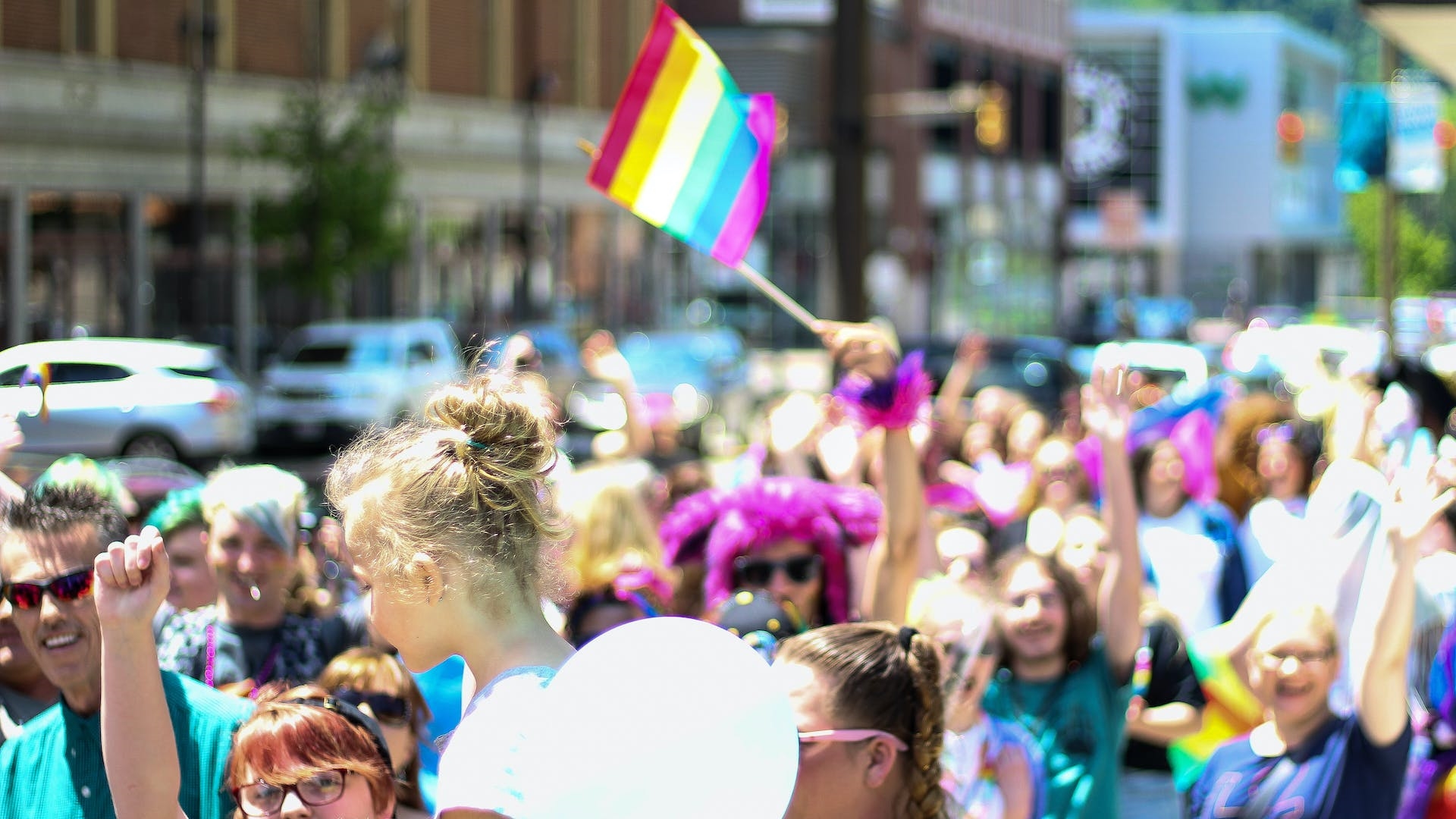 a crowd at a pride event with a lgbt flag